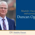 A man in a suit with the words Maddin Hauser welcomes Duncan Ogilvie