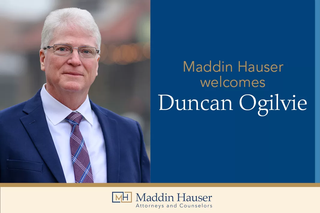 A man in a suit with the words Maddin Hauser welcomes Duncan Ogilvie